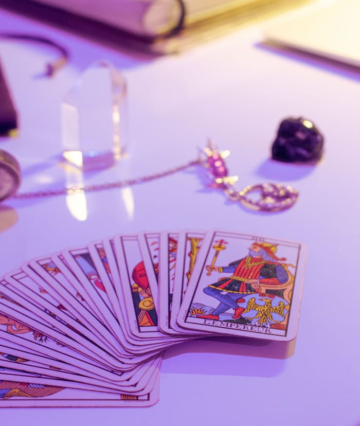 A deck of tarot cards with crystals on a mystical table setting, capturing divination vibes.